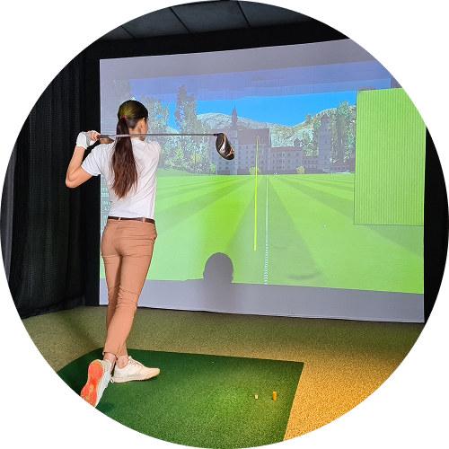 Woman swinging golf club indoors