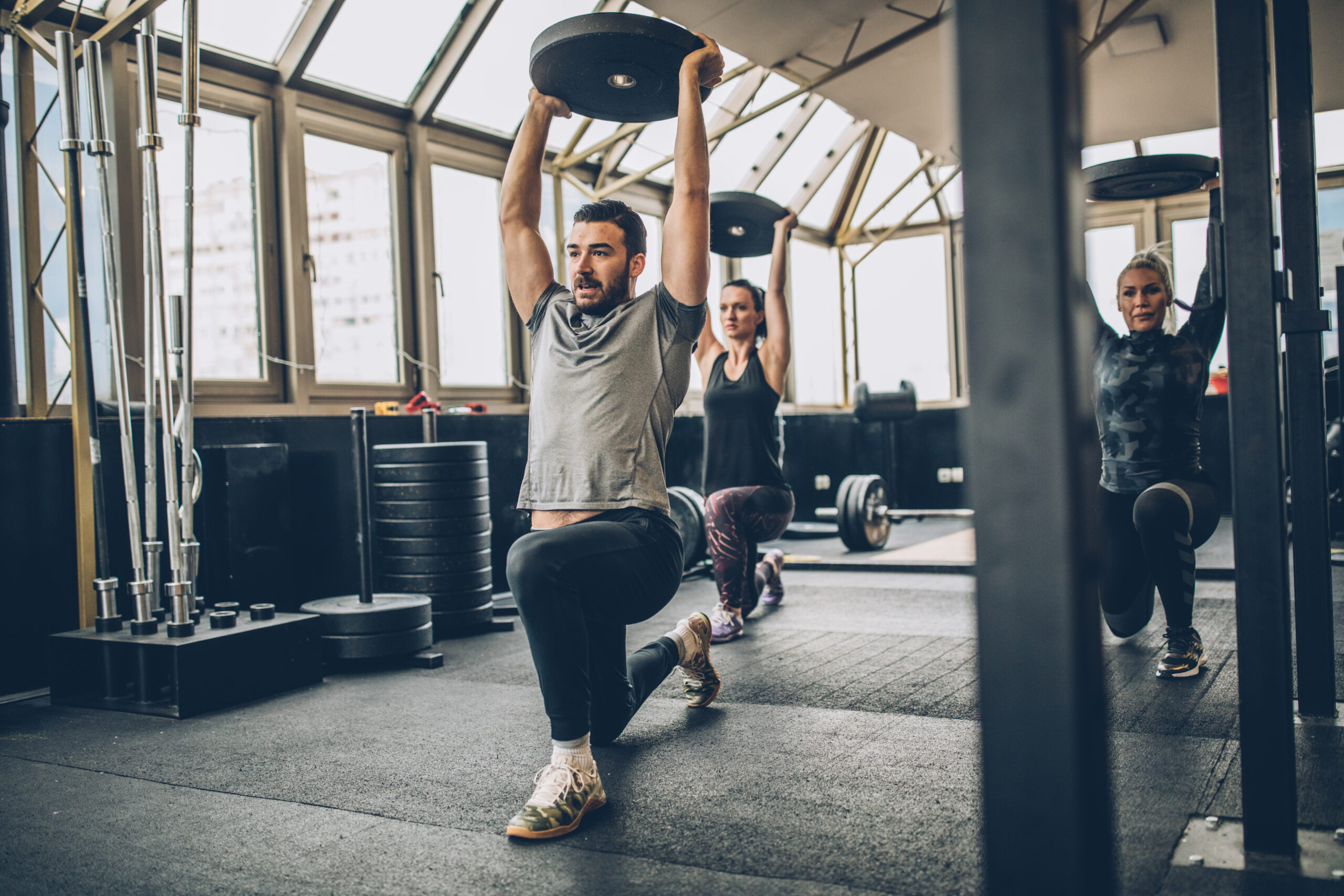 People exercising with overhead weights