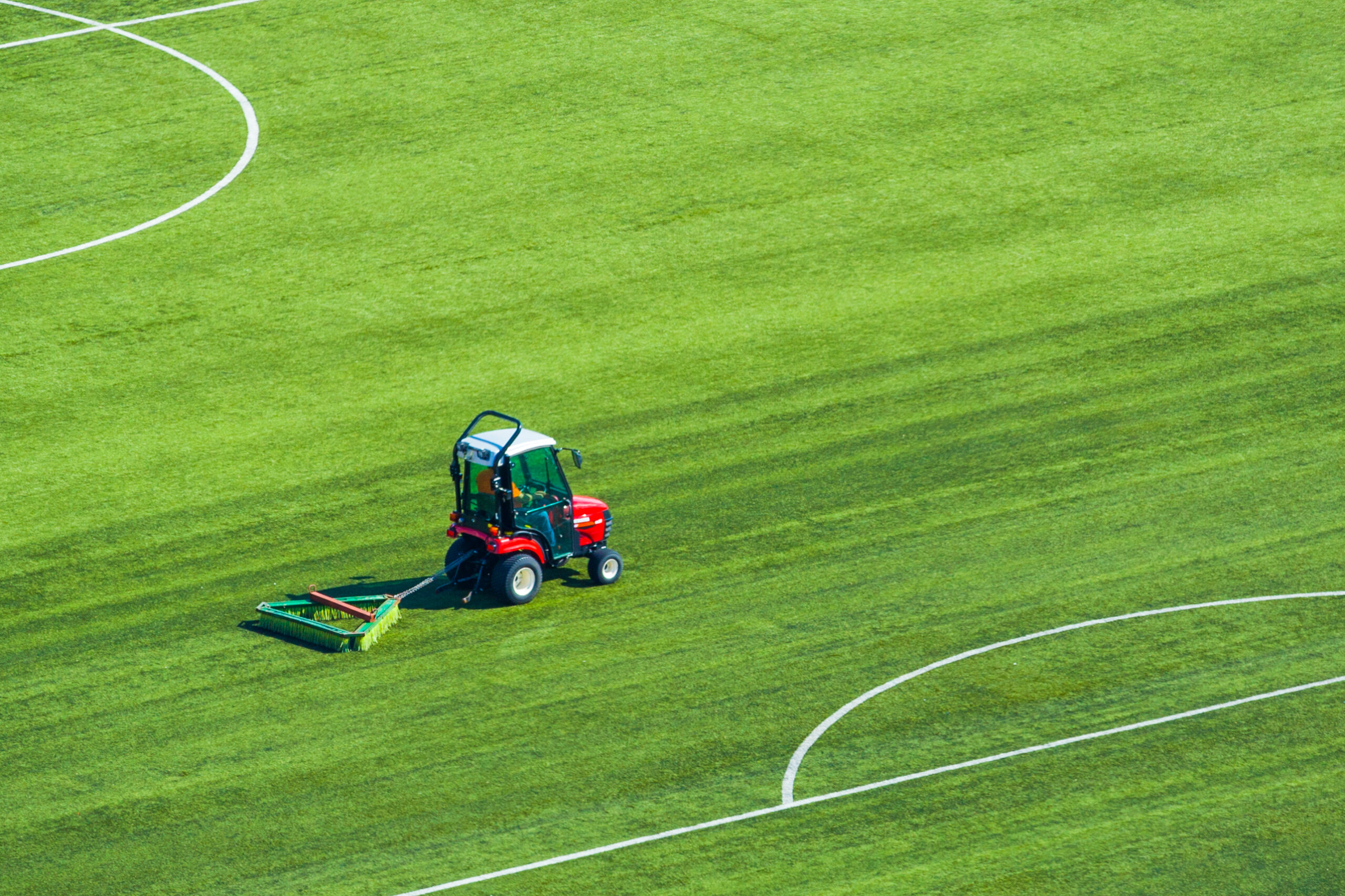 Grass maintenance on soccer pitch